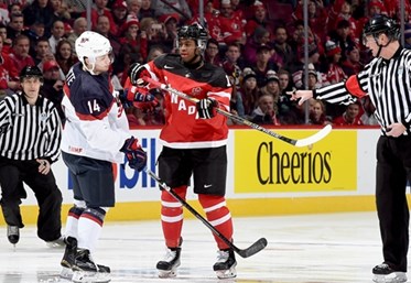 MONTREAL, CANADA - DECEMBER 31: Canada's Anthony Duclair #10 clashes with USA's Tyler Motte #14 before the puck drops to start the game during preliminary round action at the 2015 IIHF World Junior Championship. (Photo by Richard Wolowicz/HHOF-IIHF Images)

